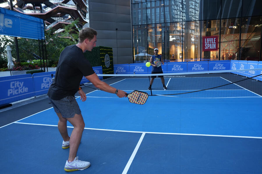 two people playing pickleball