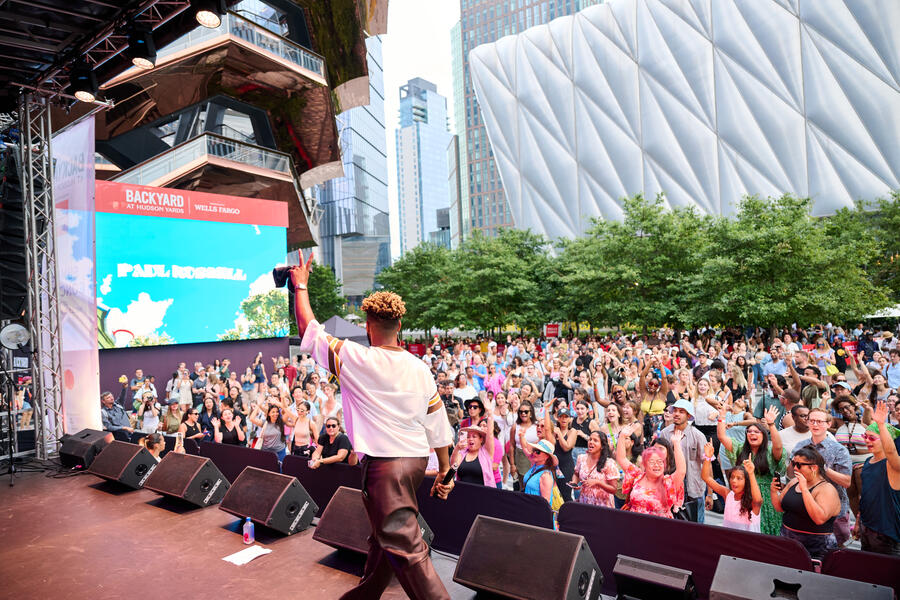 Paul Russell perfroming on stage at Hudson Yards