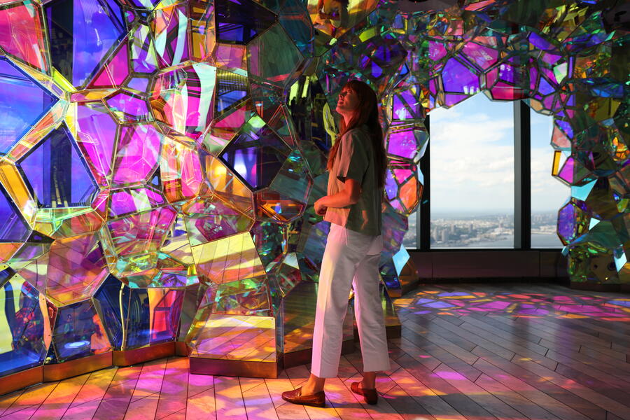 women standing underneath crystal like structures