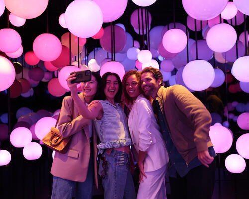 Group of people taking a selfi inside Edge's new immersive experience