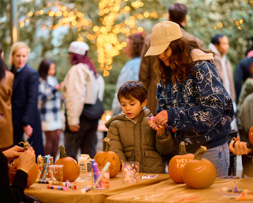 Mother and son painting a pumpkin