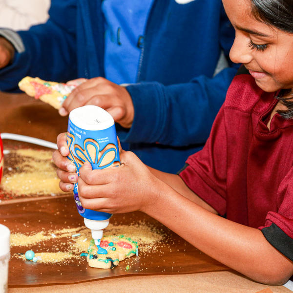 children decorating cookies with icing