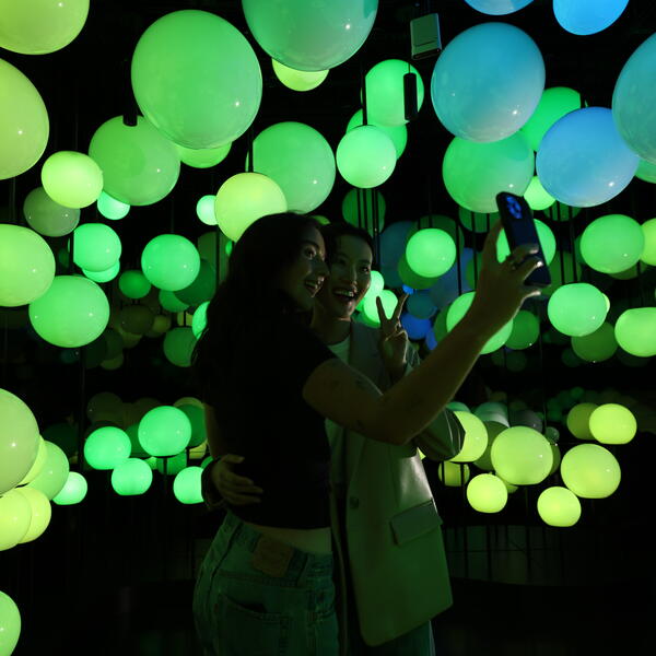 two girls taking a selfie against Pulse 