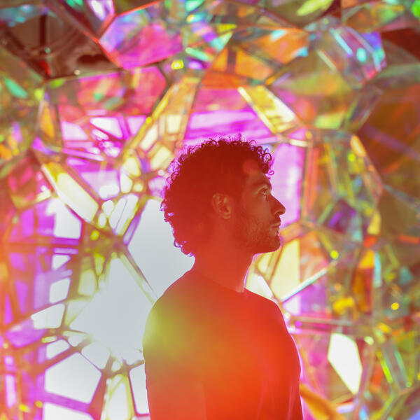 person with light reflecting off of the glass crystals