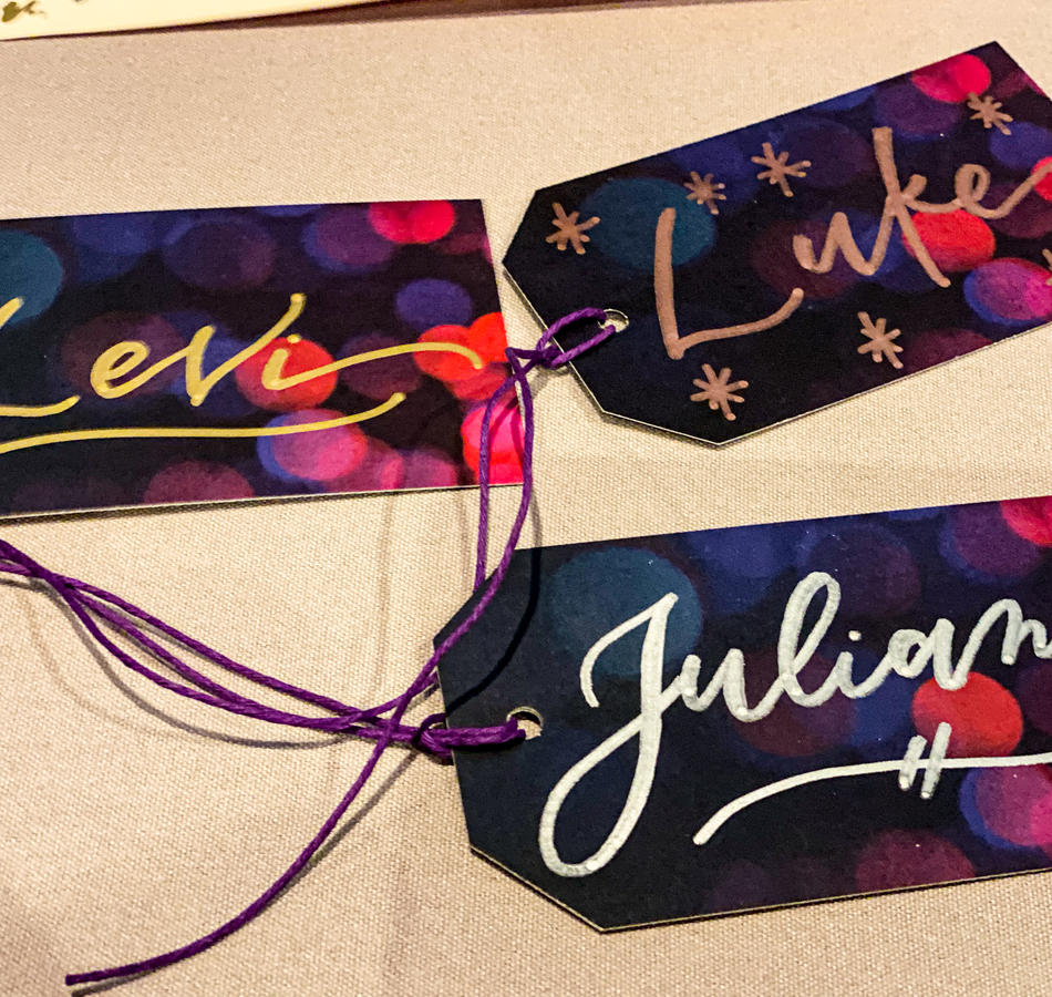 Calligraphy gift tags on purple and pink tags