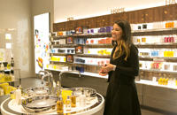 Woman shopping for soaps at Molton Brown