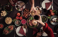 people toasting over a holiday dinner spread